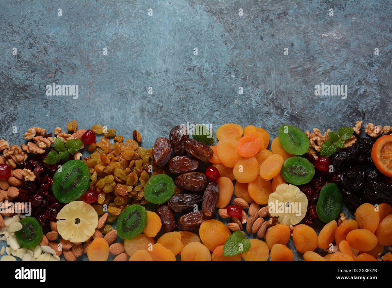 Mix of dried and sundried fruits, and nuts. Kiwi, apricot. Symbols of