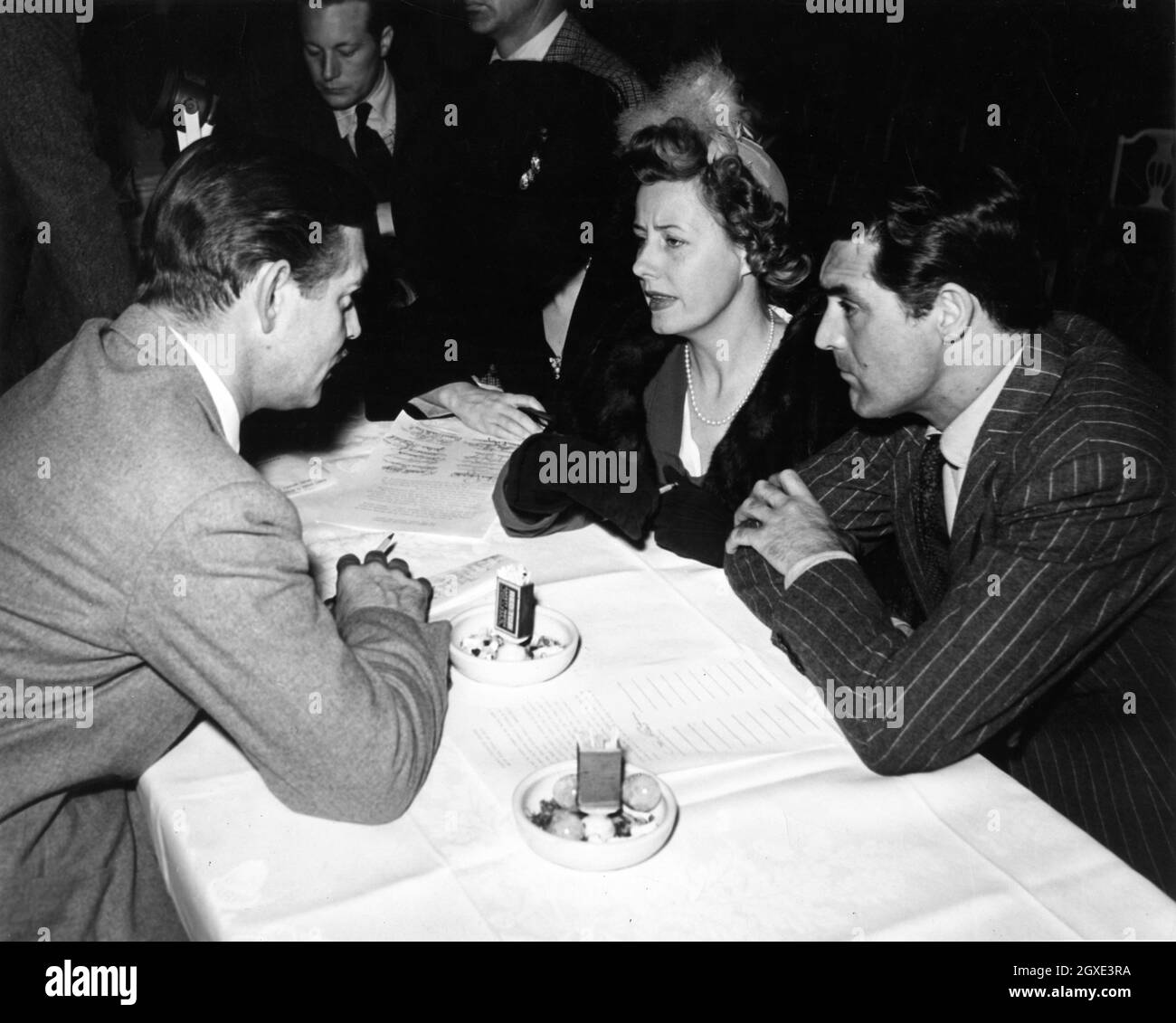 CLARK GABLE GENE RAYMOND (in background) IRENE DUNNE and CARY GRANT at SCREEN ACTORS GUILD MEETING in December 1941 Stock Photo