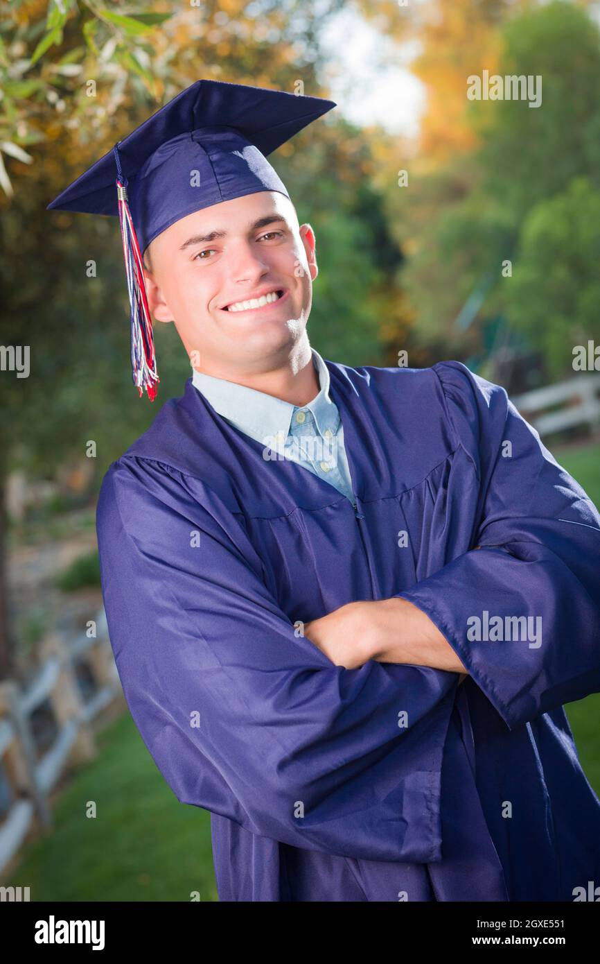 Happy Handsome Male Graduate in Cap and Gown Outside Stock Photo - Alamy