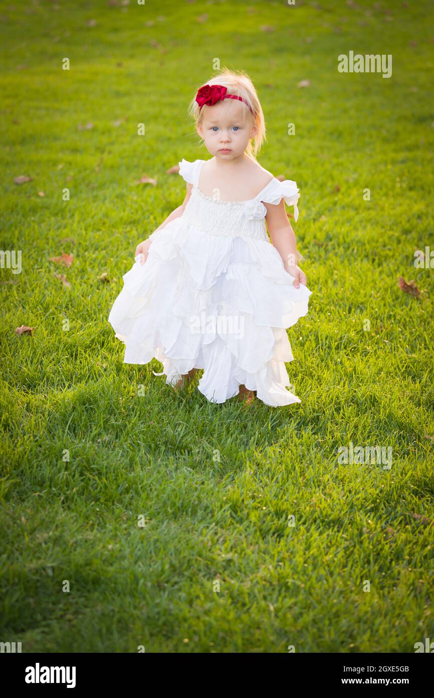 Beautiful Adorable Little Girl Wearing White Dress In A Grass Field ...