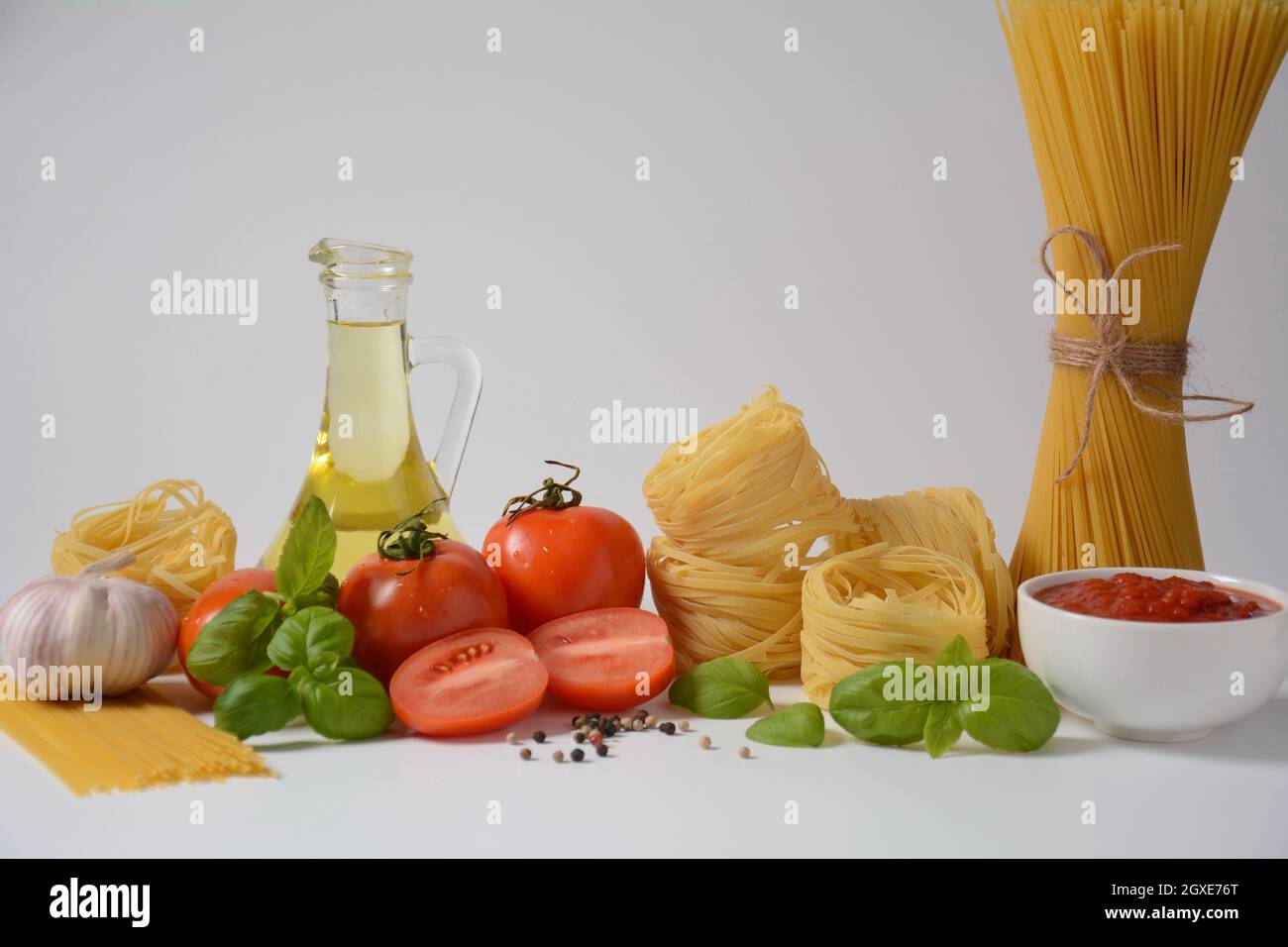 Food ingredients for Italian pasta, tomatoes basil garlic olive oil and parmesan cheese Stock Photo