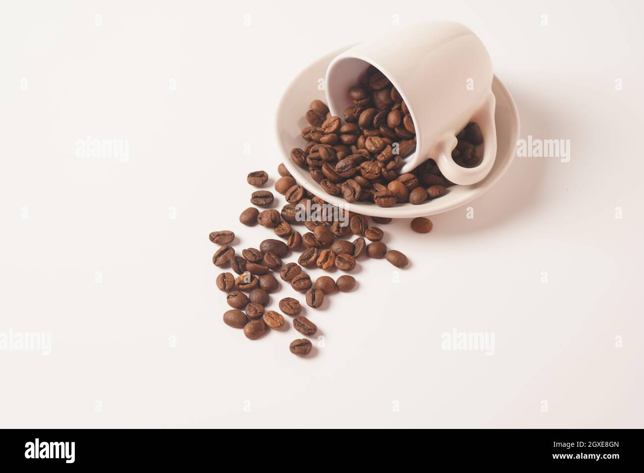 Coffee cup and coffee beans on white background Stock Photo - Alamy