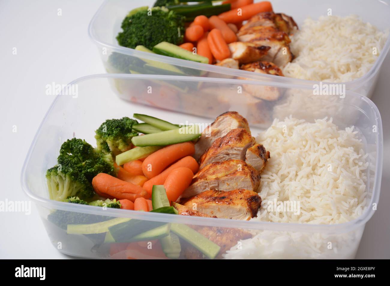 Healthy balanced lunch boxes. Grilled chicken, carrots, cucumbers