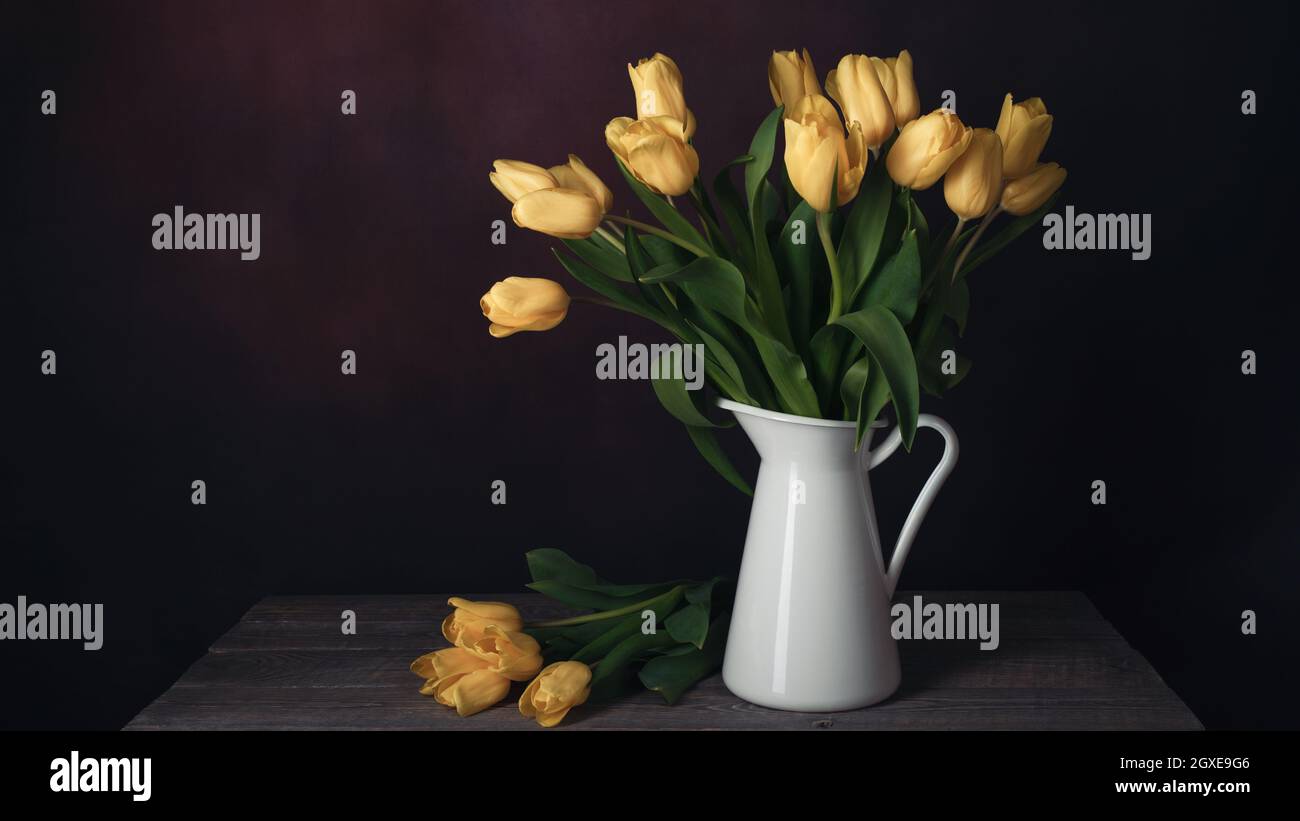 Tulips in a jug. Classic still life with a bouquet of yellow tulip ...