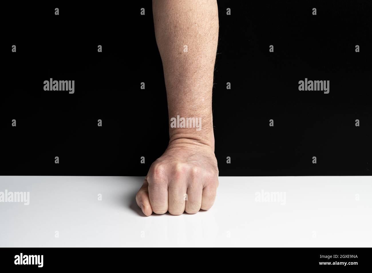 a clenched fist on the table Stock Photo Alamy