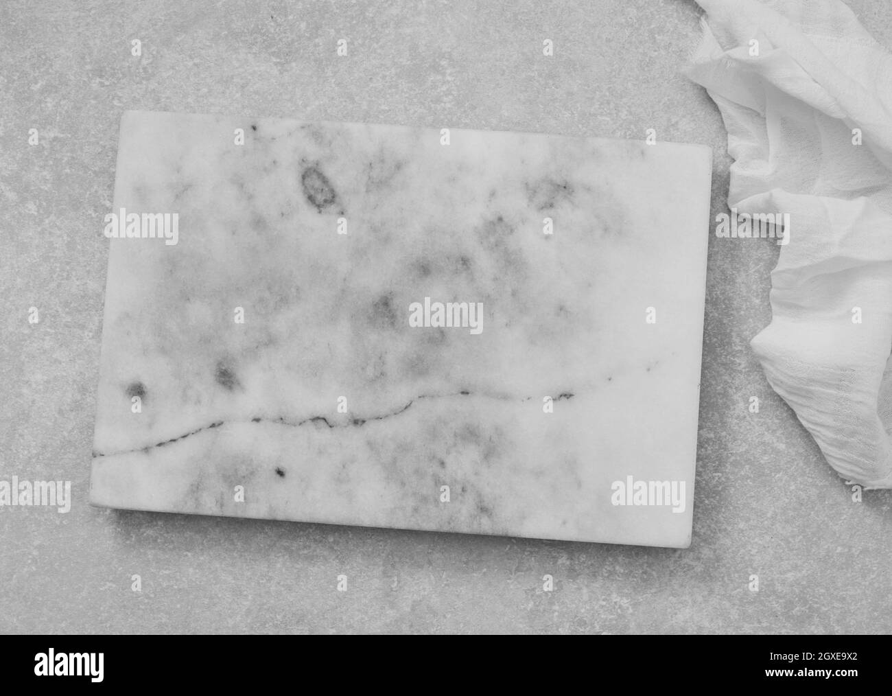 Empty marble cutting board on white table Stock Photo