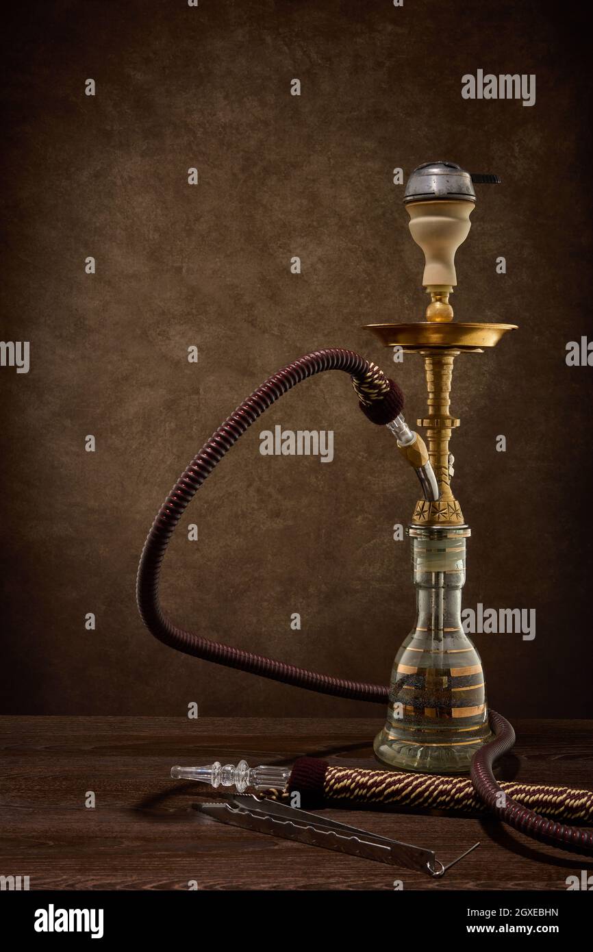 Egyptian hookah (shisha) on dark brown table on dark background Stock Photo  - Alamy
