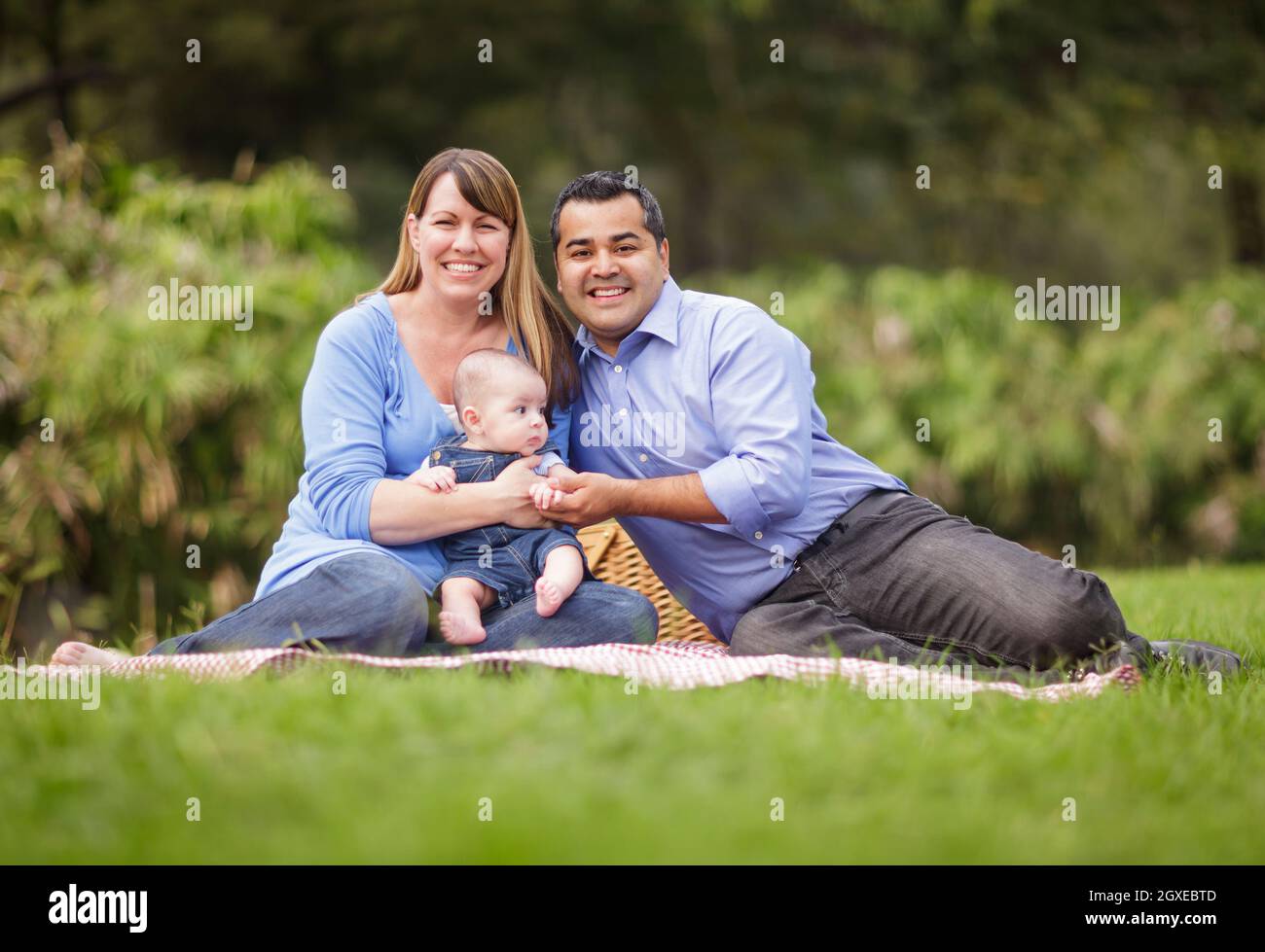 Happy Mixed Race Family Having a Picnic and Playing In The Park Stock ...