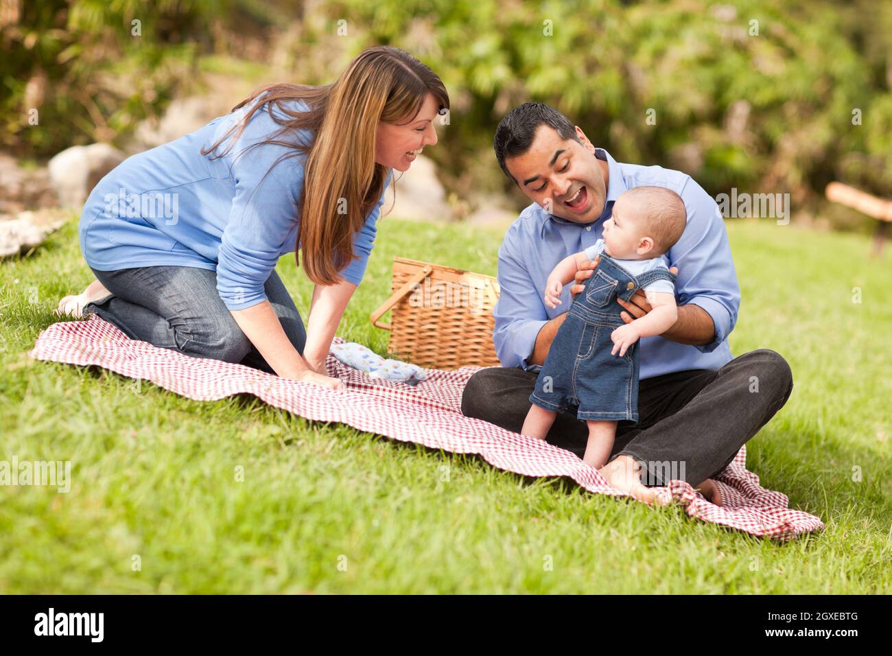 Happy Mixed Race Family Having a Picnic and Playing In The Park Stock ...
