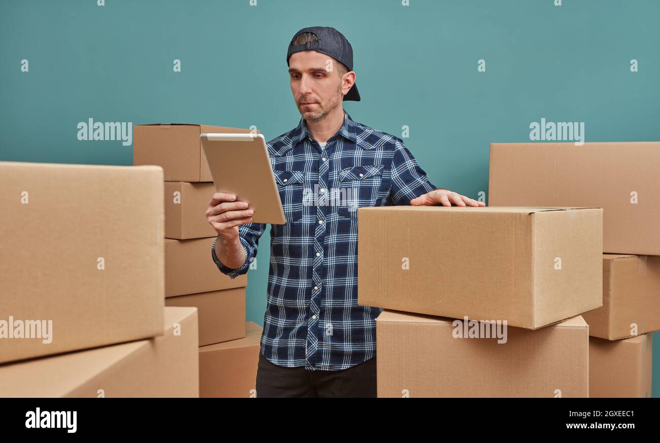 Man organizing cardboard boxes Stock Photo - Alamy
