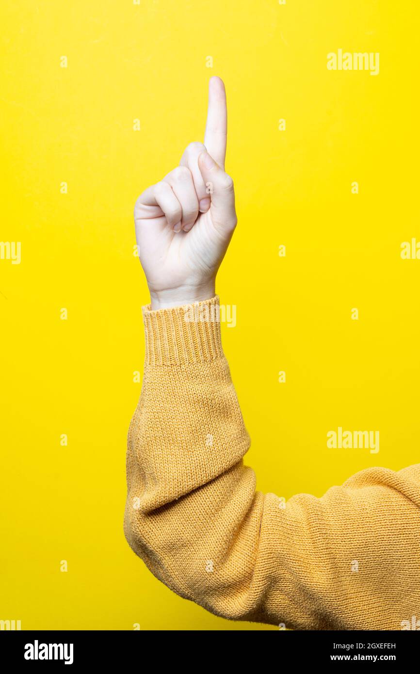 a woman's index finger pointing upwards Stock Photo