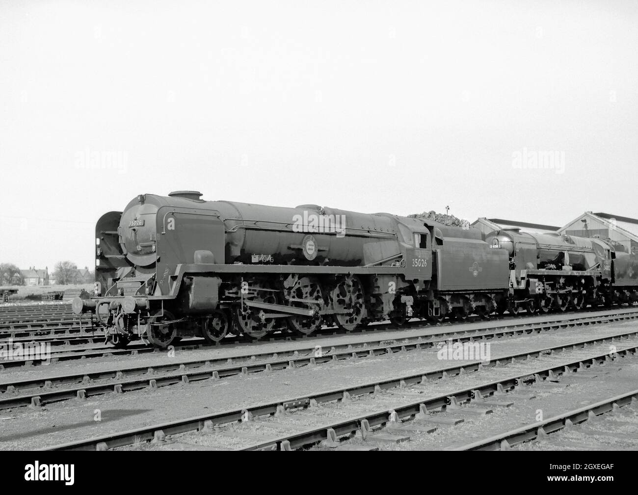 Merchant Navy Class No 35026 Lamport and Holt Line and Battle of Britain Class No 34082 615 Squadron at Eastleigh, 18th April 1964 Stock Photo
