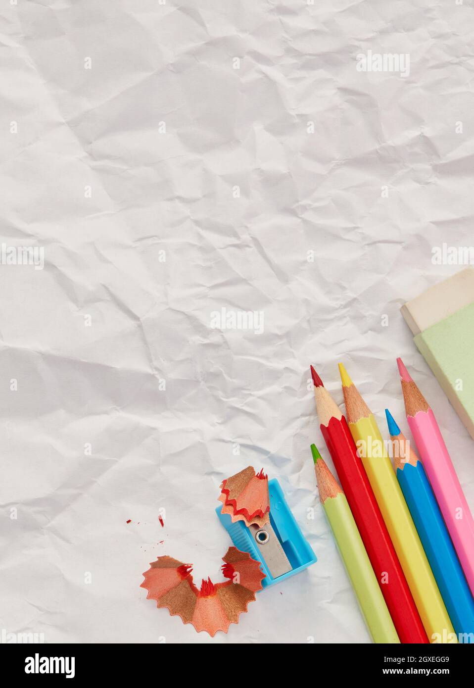 Pencils and sharpener on blank paper Stock Photo