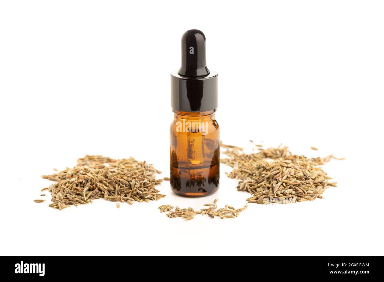 Cumin essential oil bottle isolated on white background. Cuminum ...