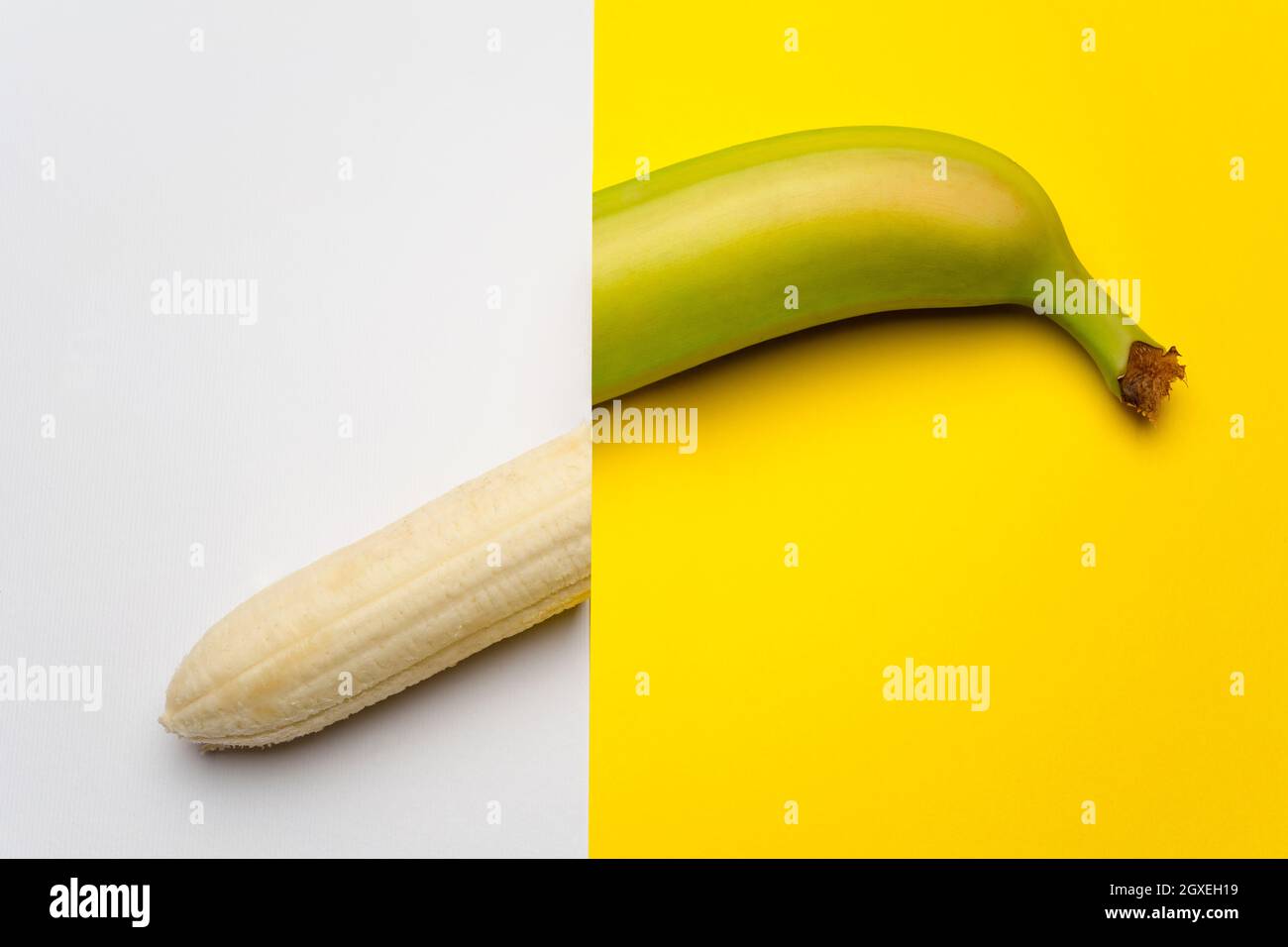 the banana cut in half on a colored surface Stock Photo Alamy