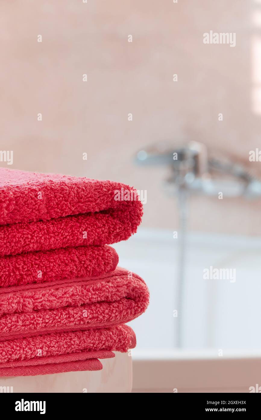 Folded pink towels in bathroom Stock Photo