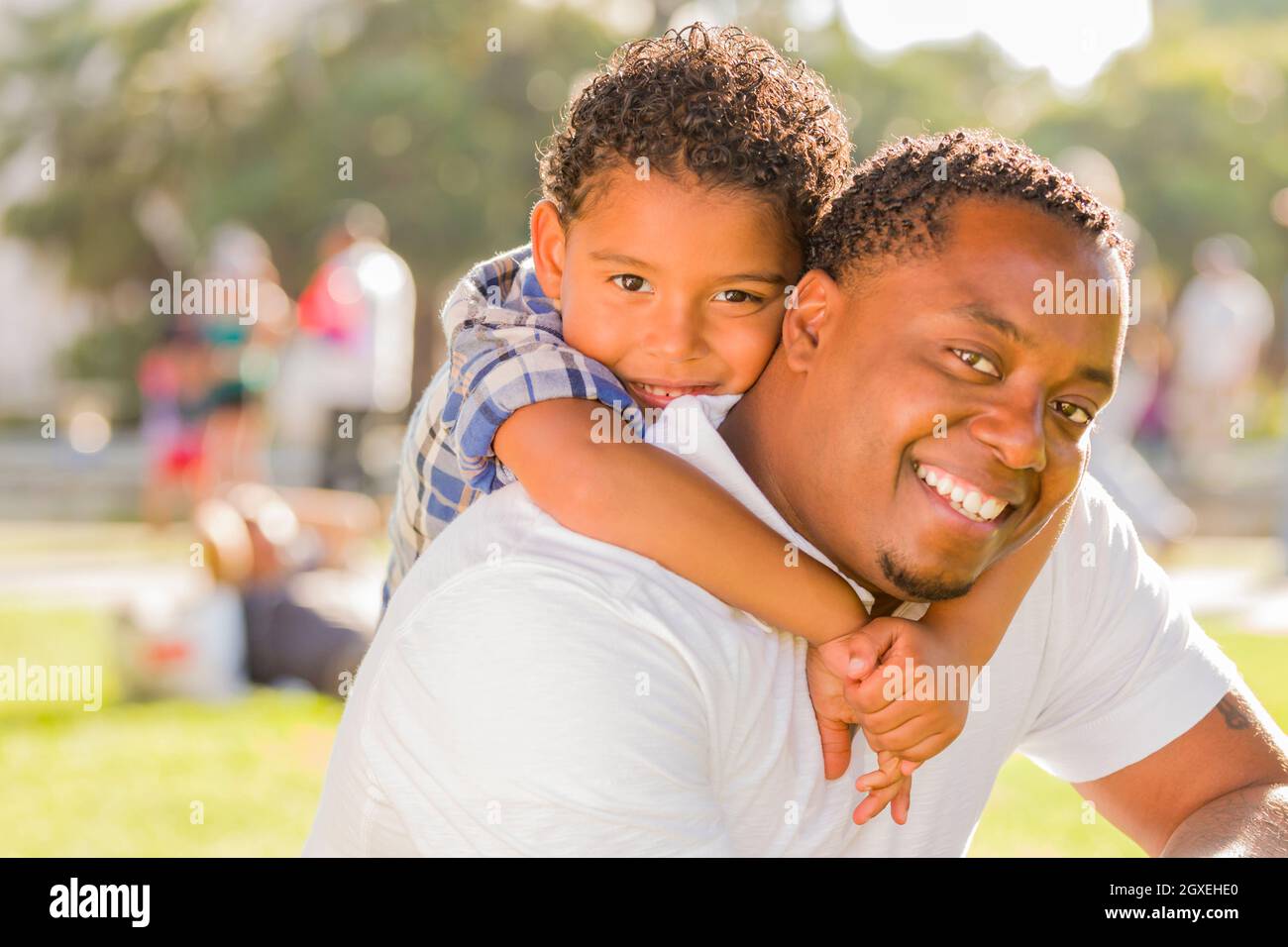 Happy African American Father and Mixed Race Son Playing Piggyback in ...