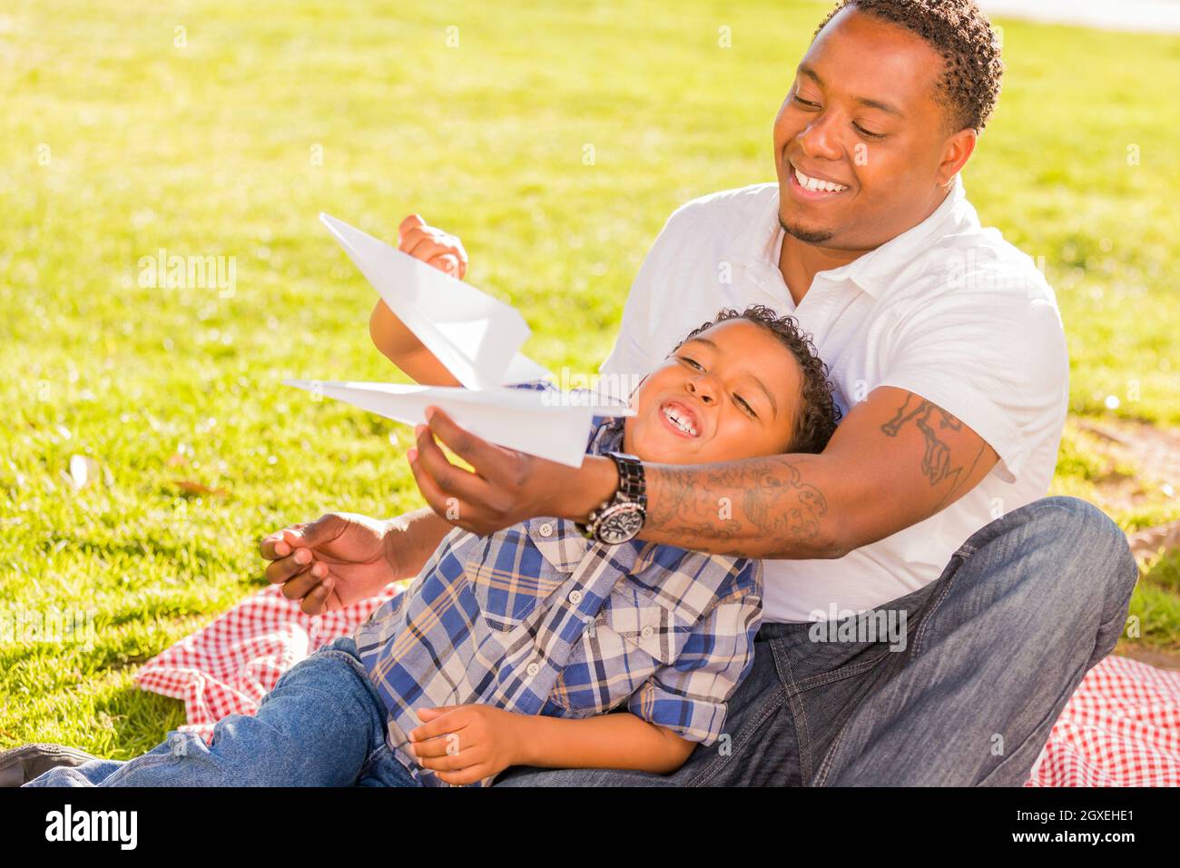 Happy African American Father and Mixed Race Son Playing with Paper ...