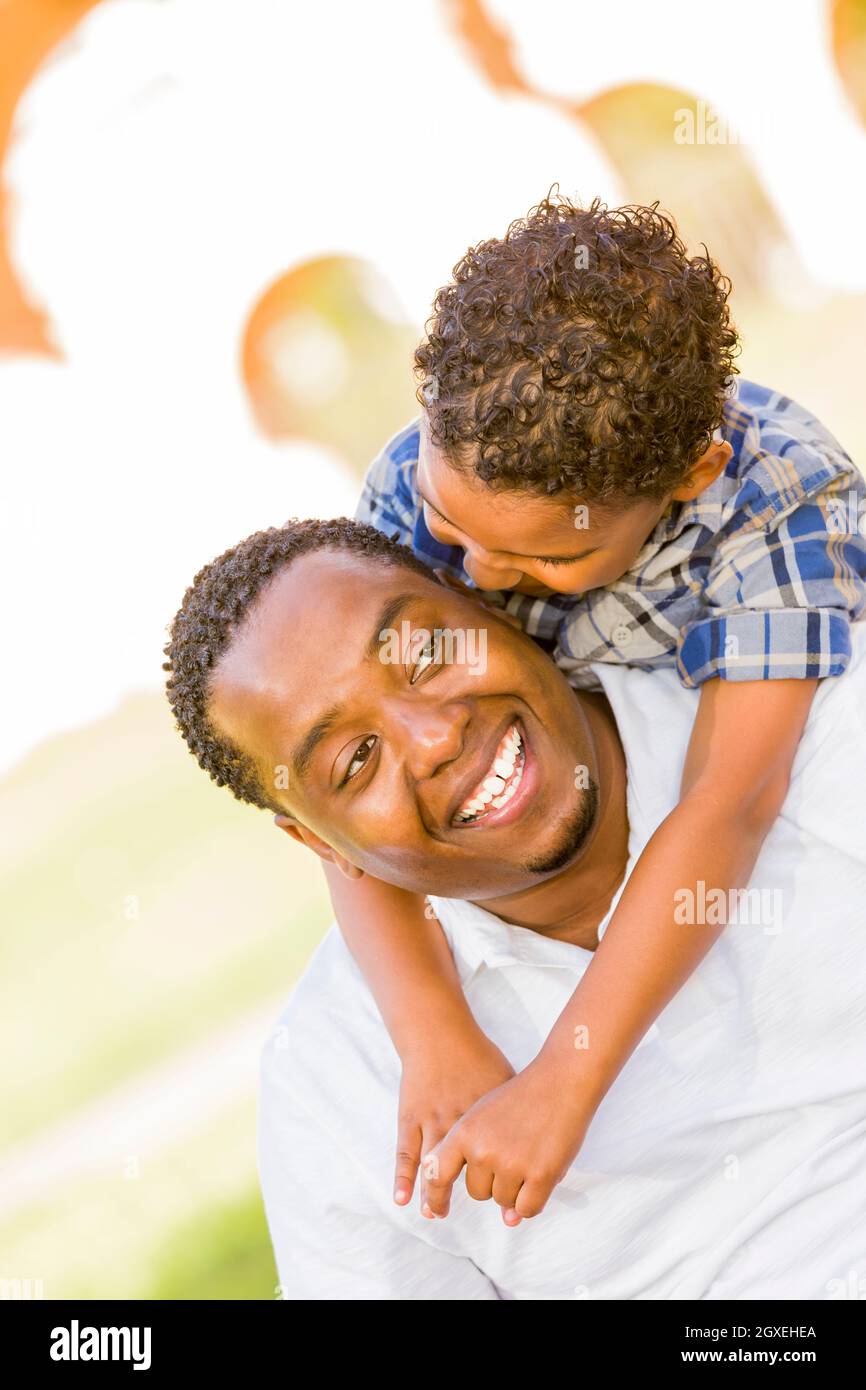 Happy African American Father and Mixed Race Son Playing Piggyback in ...