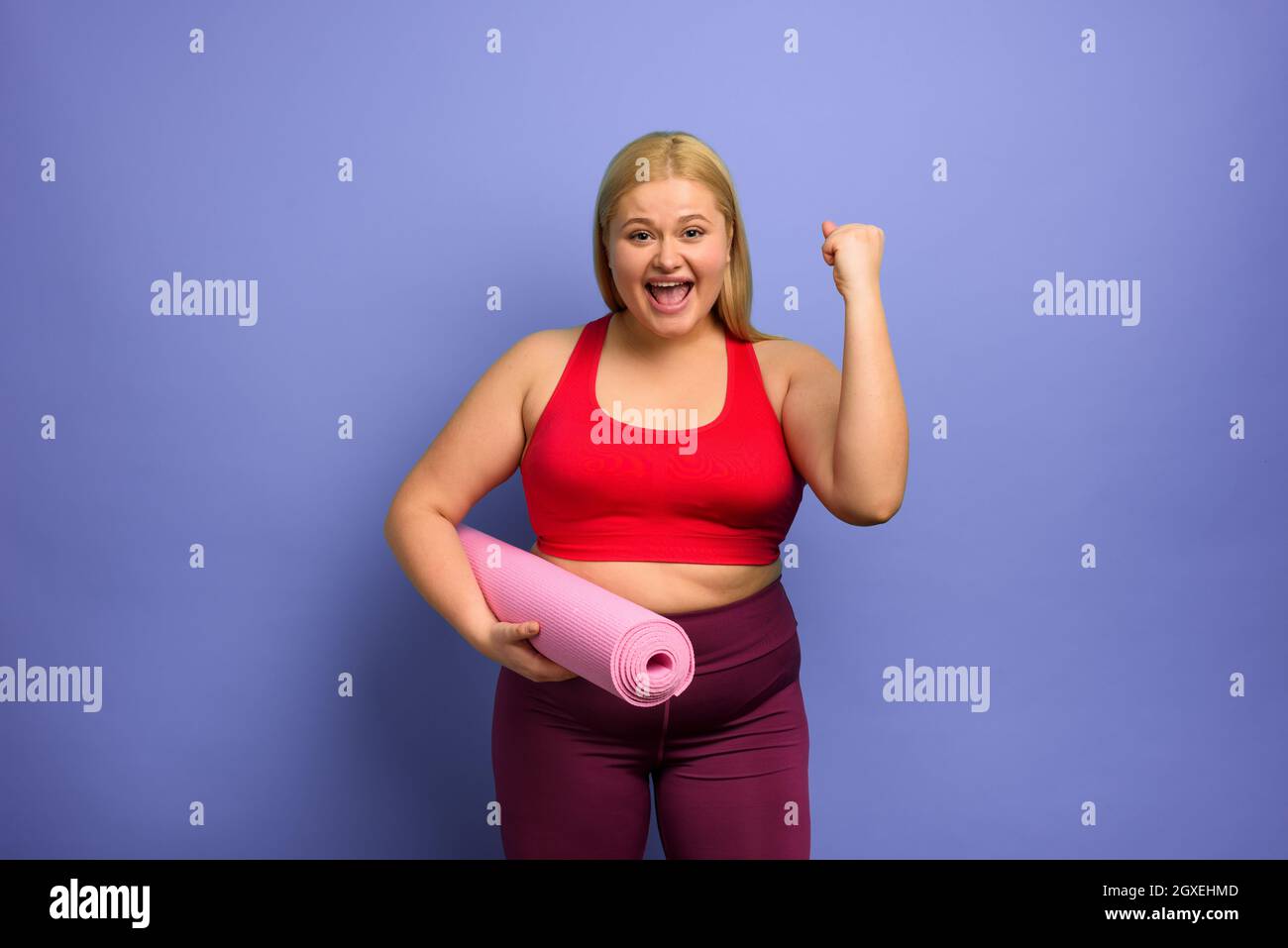 Fat girl does gym at home. satisfied expression. Cyan background Stock  Photo - Alamy