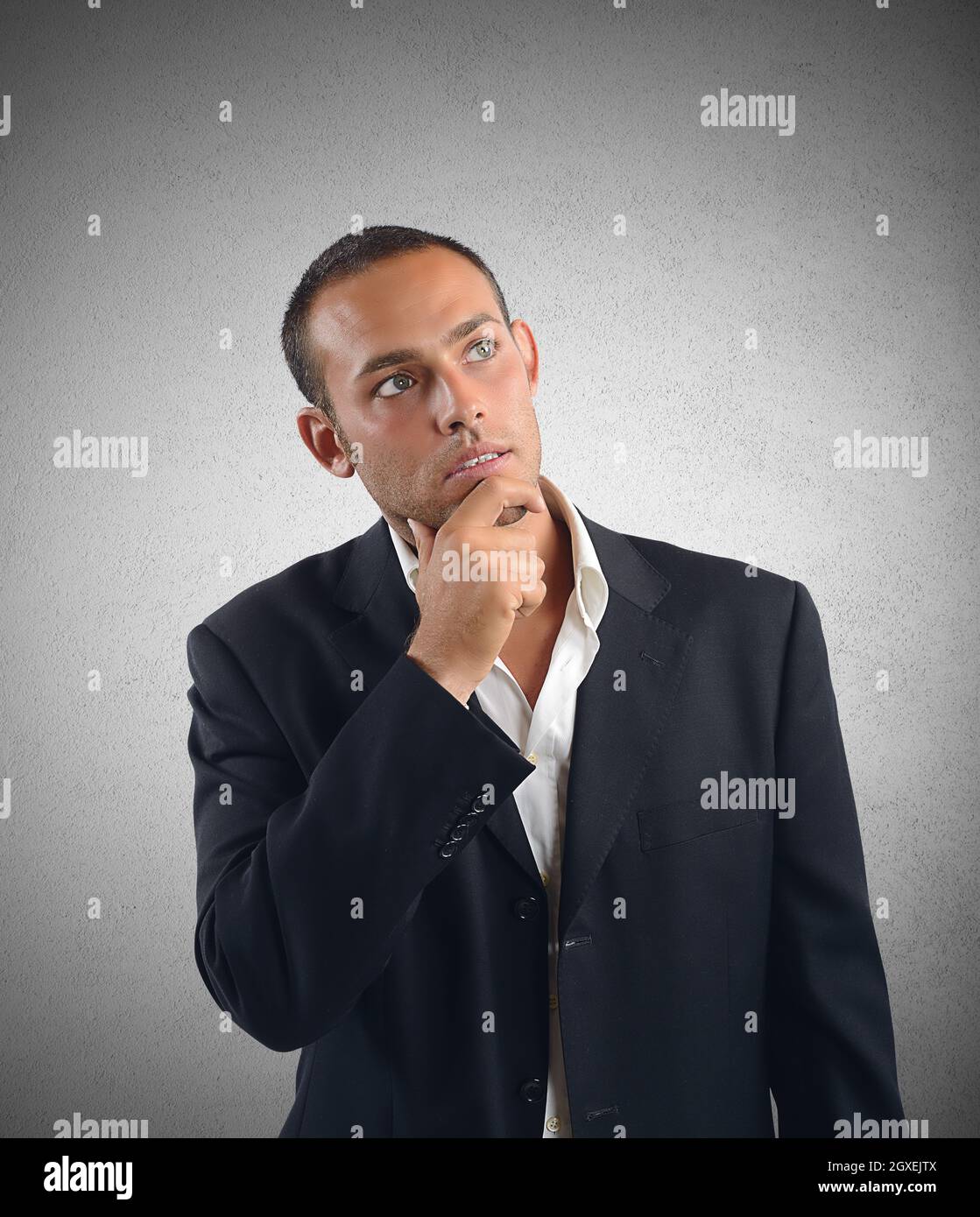 Businessman reflects on what decision to take Stock Photo