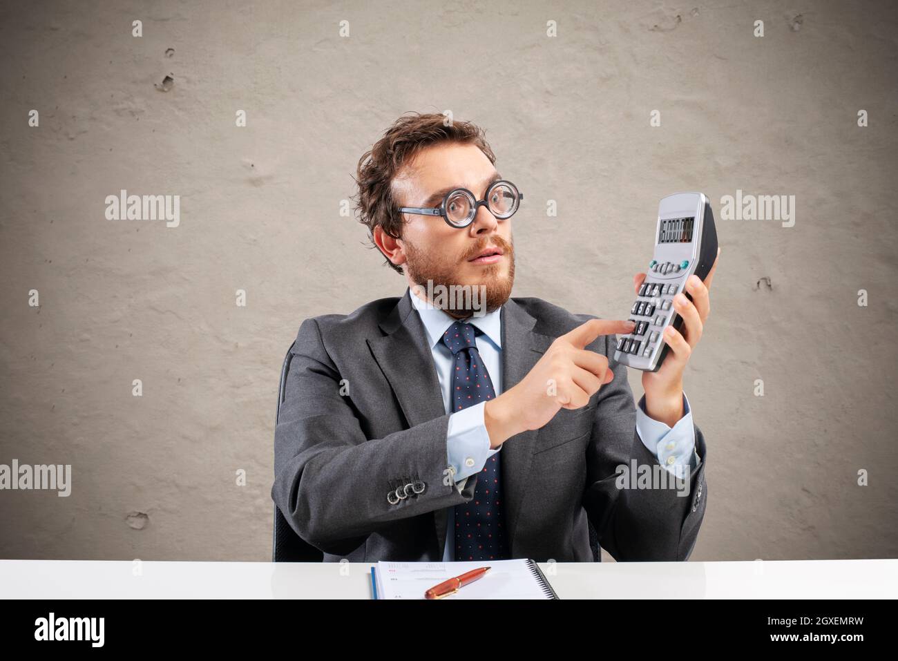 Nerd Accountant Does Complex Calculation Of Company Revenue Stock Photo Nerd accountant does complex calculation of company revenue stock photo