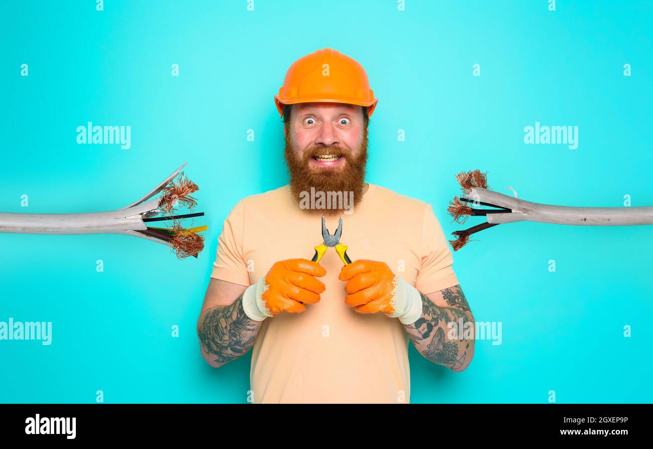 Incompetent worker electrician is unsure about his work Stock Photo