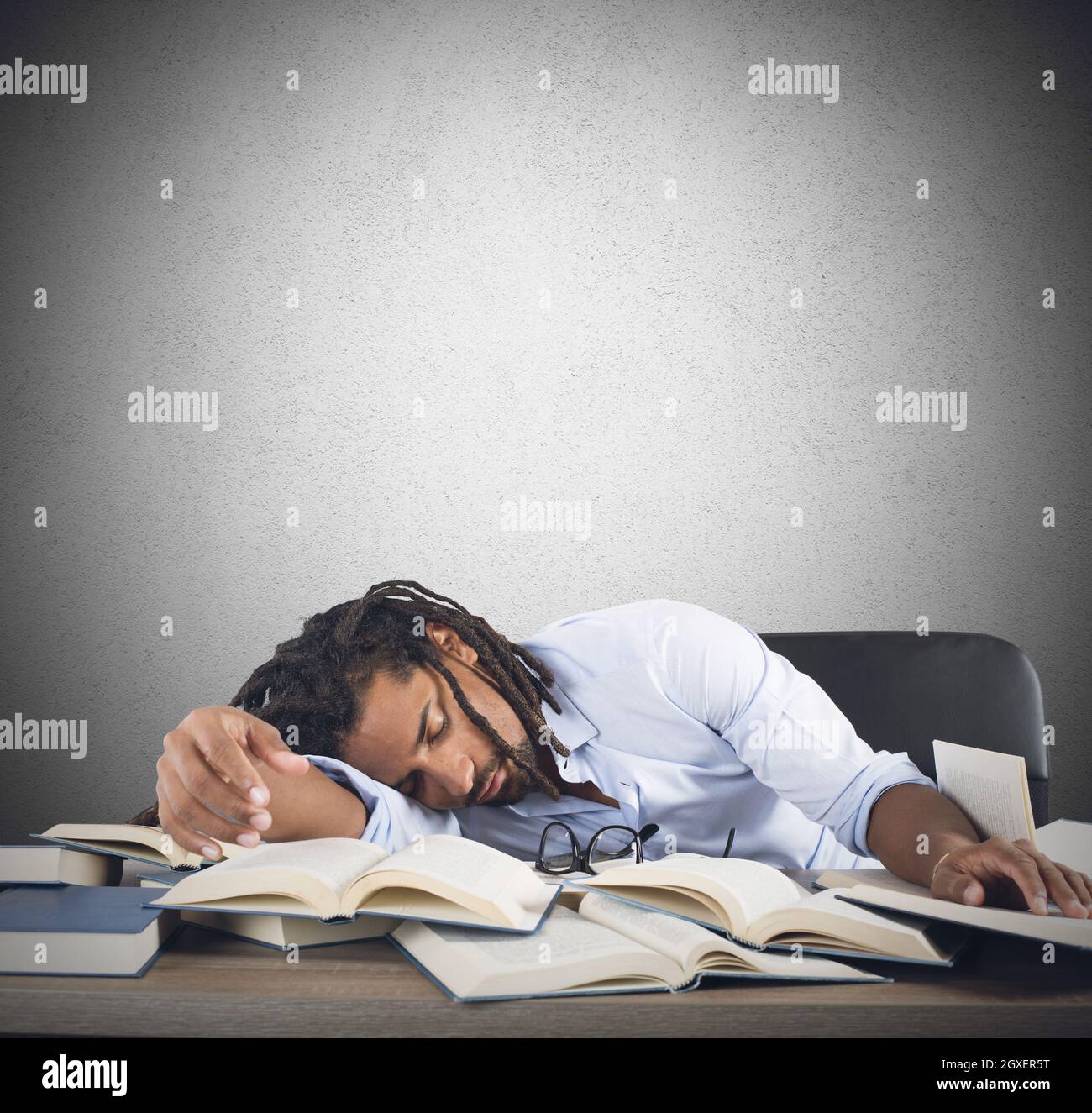 Tired teacher falls asleep while reading books Stock Photo Alamy