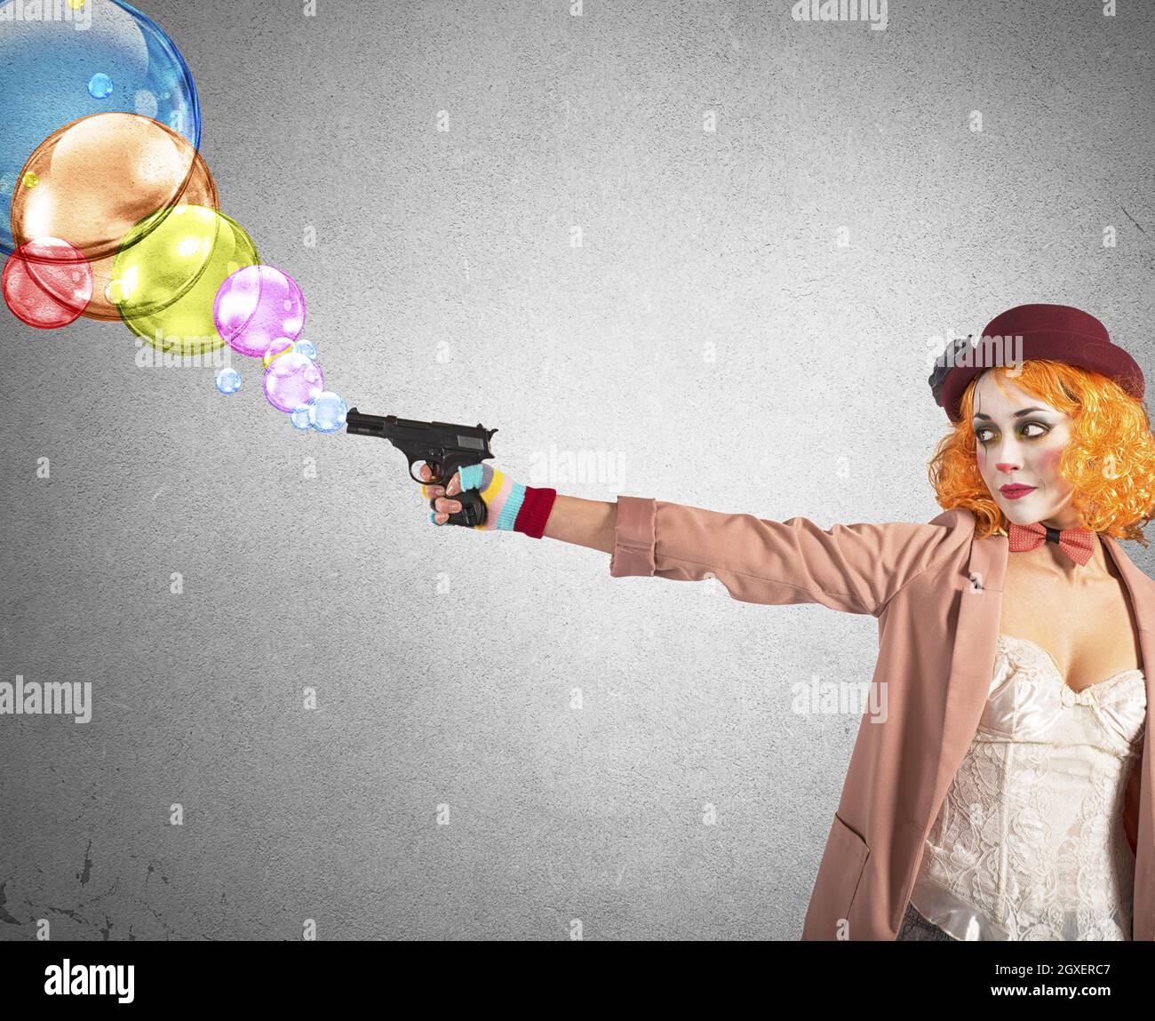 Clown thief shoots bubbles from her gun Stock Photo