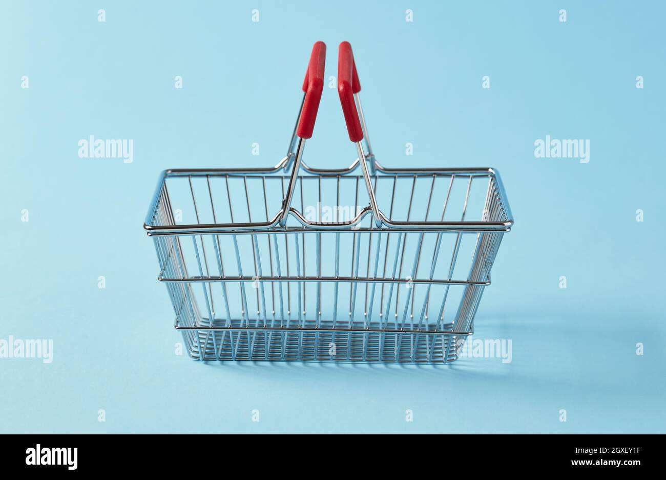 Empty shopping basket on blue background Stock Photo