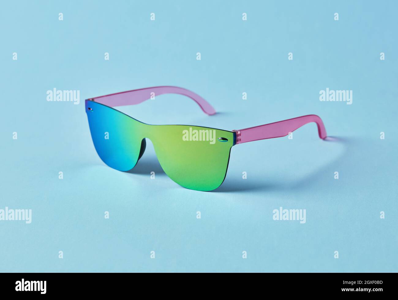 Summer multi-colored sunglasses on blue background Stock Photo