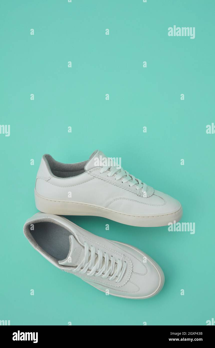 White classic shoes on green background Stock Photo
