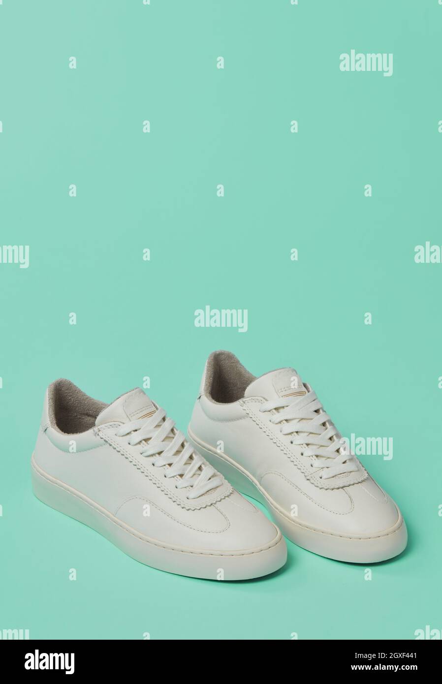 White classic shoes on green background Stock Photo