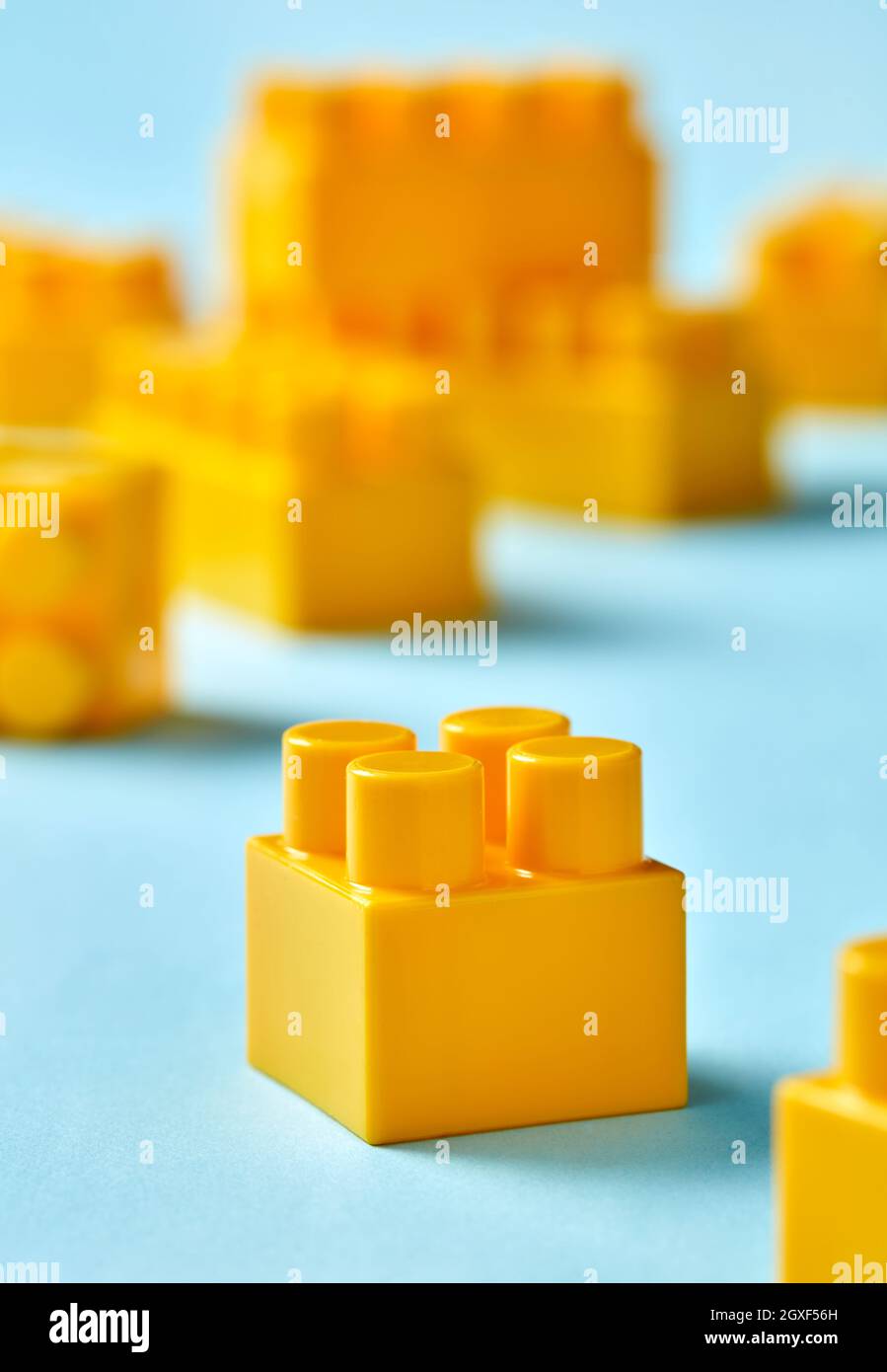 Plastic toy blocks on blue background Stock Photo