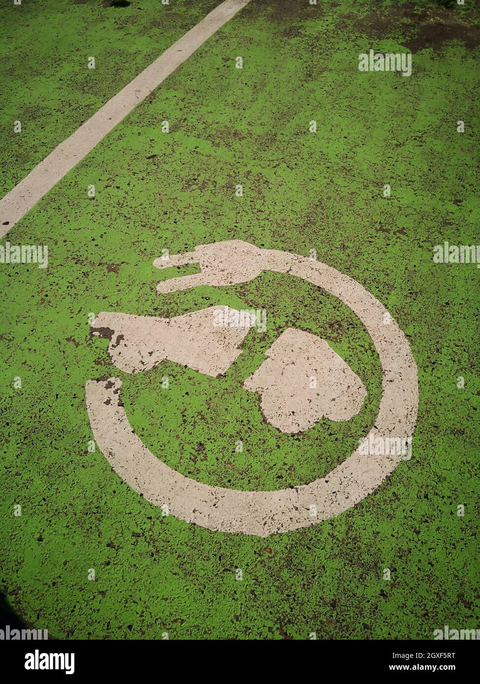 Painted sign for electric vehicle parking on the ground. Stock Photo