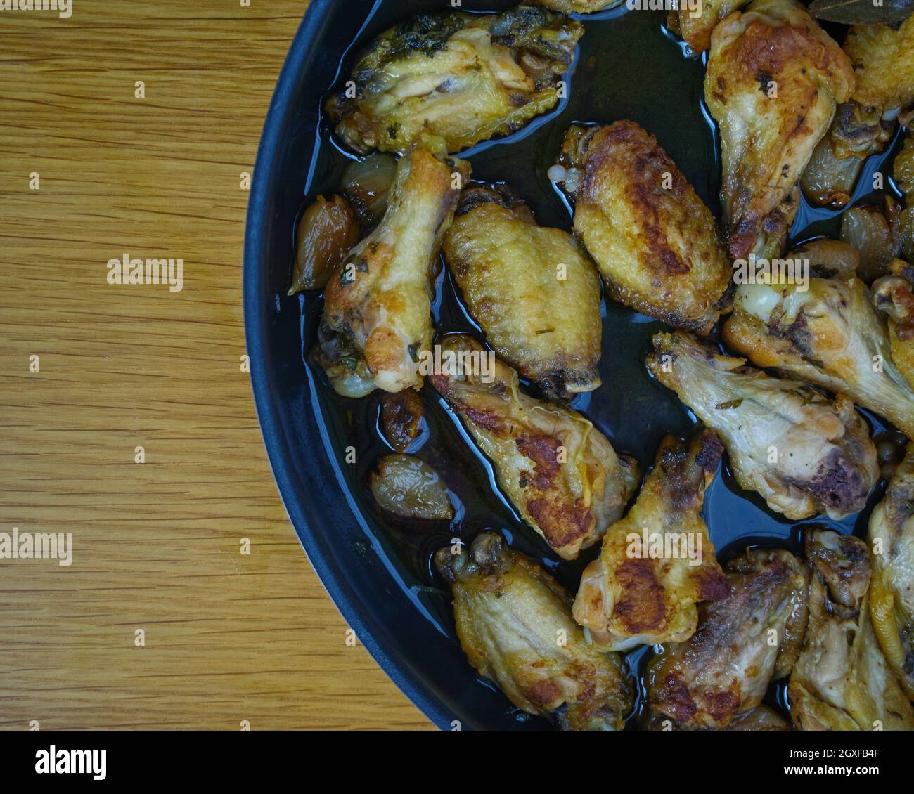 Garlic Chicken Wings (Pollo al ajillo). Spanish Tapa dish in frying pan