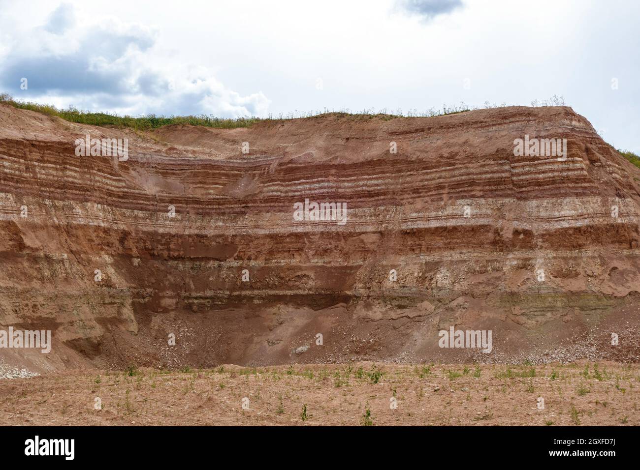 Working wall in industrial quarry (open-pit mining). It can be seen layers of underground resources Stock Photo