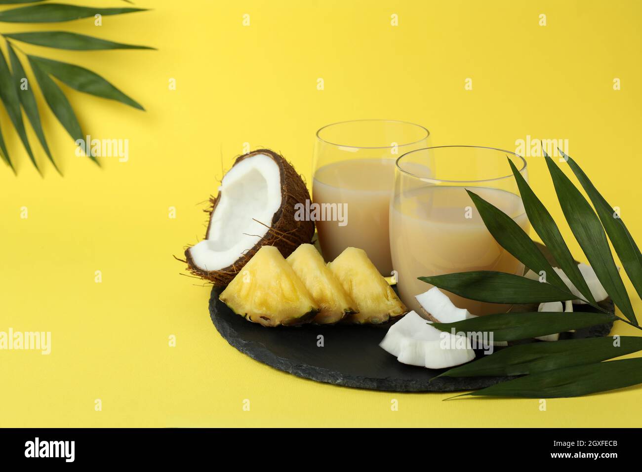 Pina colada cocktails and ingredients on yellow background Stock Photo