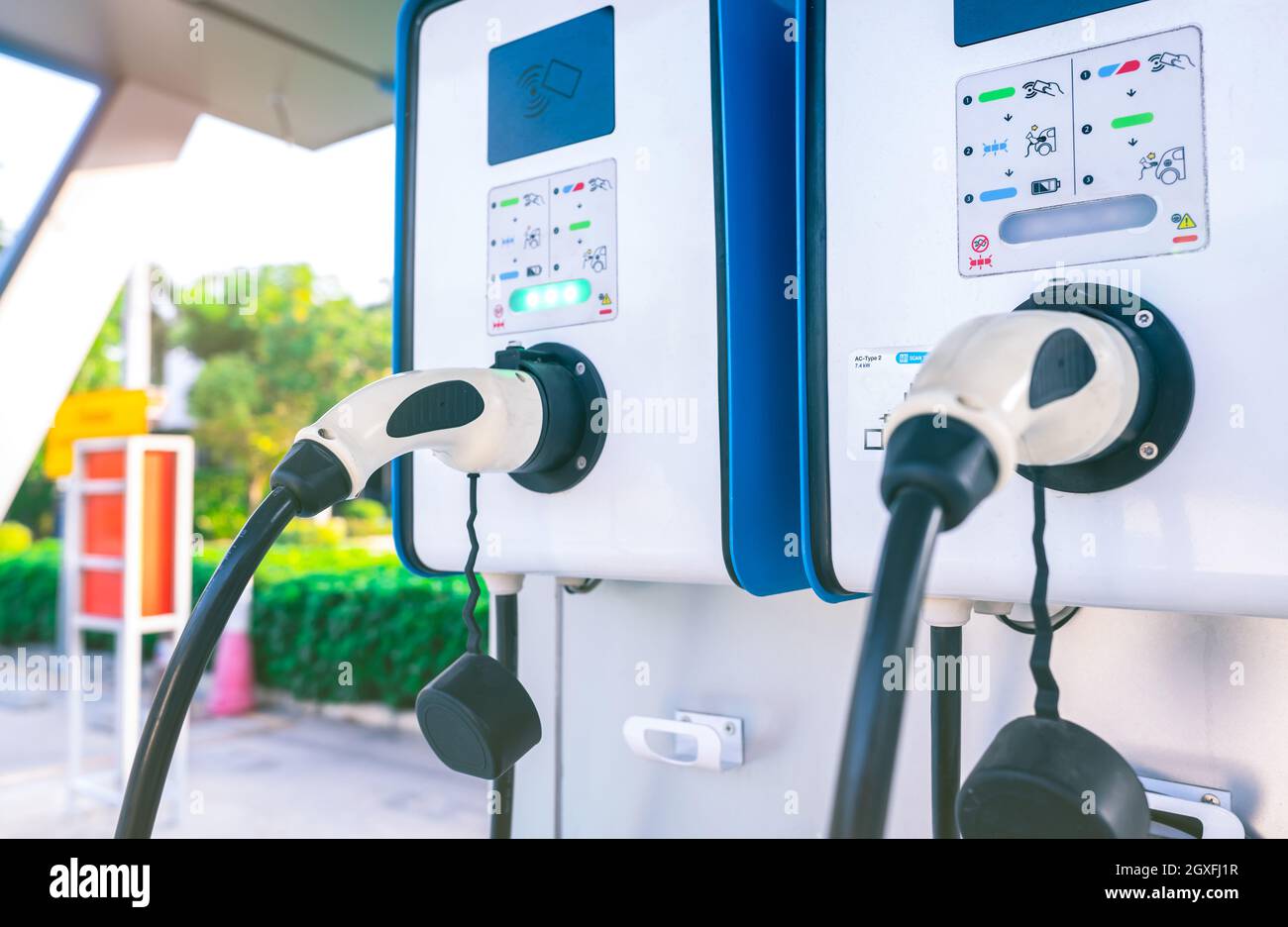 Electric car charging station for charge EV battery. Plug for vehicle with electric engine. EV charger. Clean energy. Charging point at car parking lo Stock Photo
