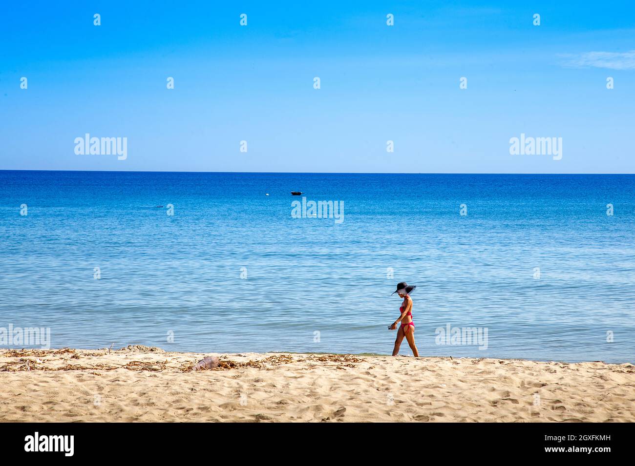 girl in red bikini walking on the beach at anbang beach, Vietnam Stock
