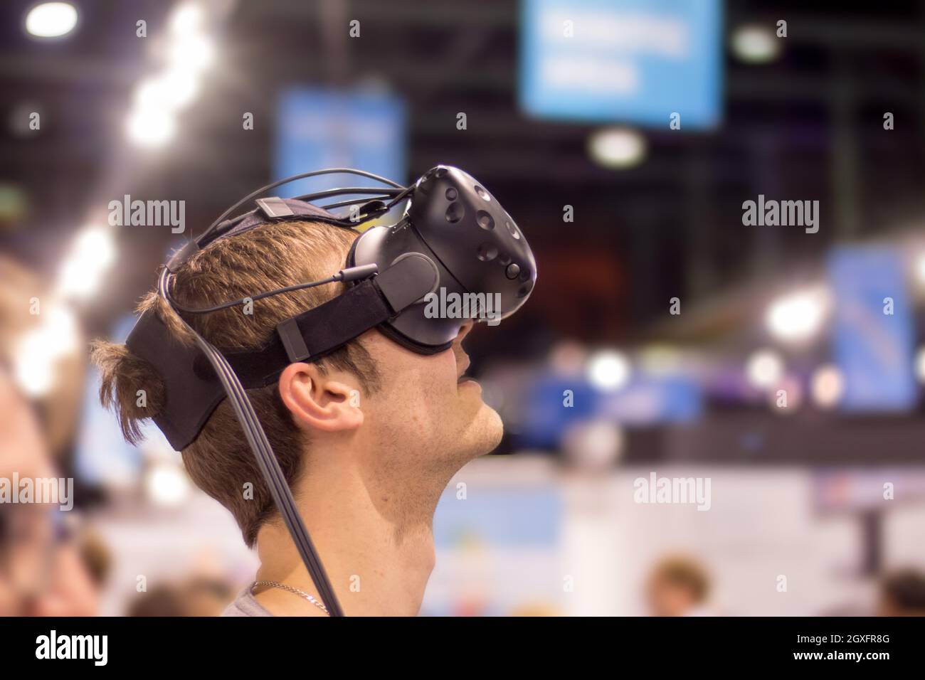 Young man is using virtual reality glasses on an expo Stock Photo