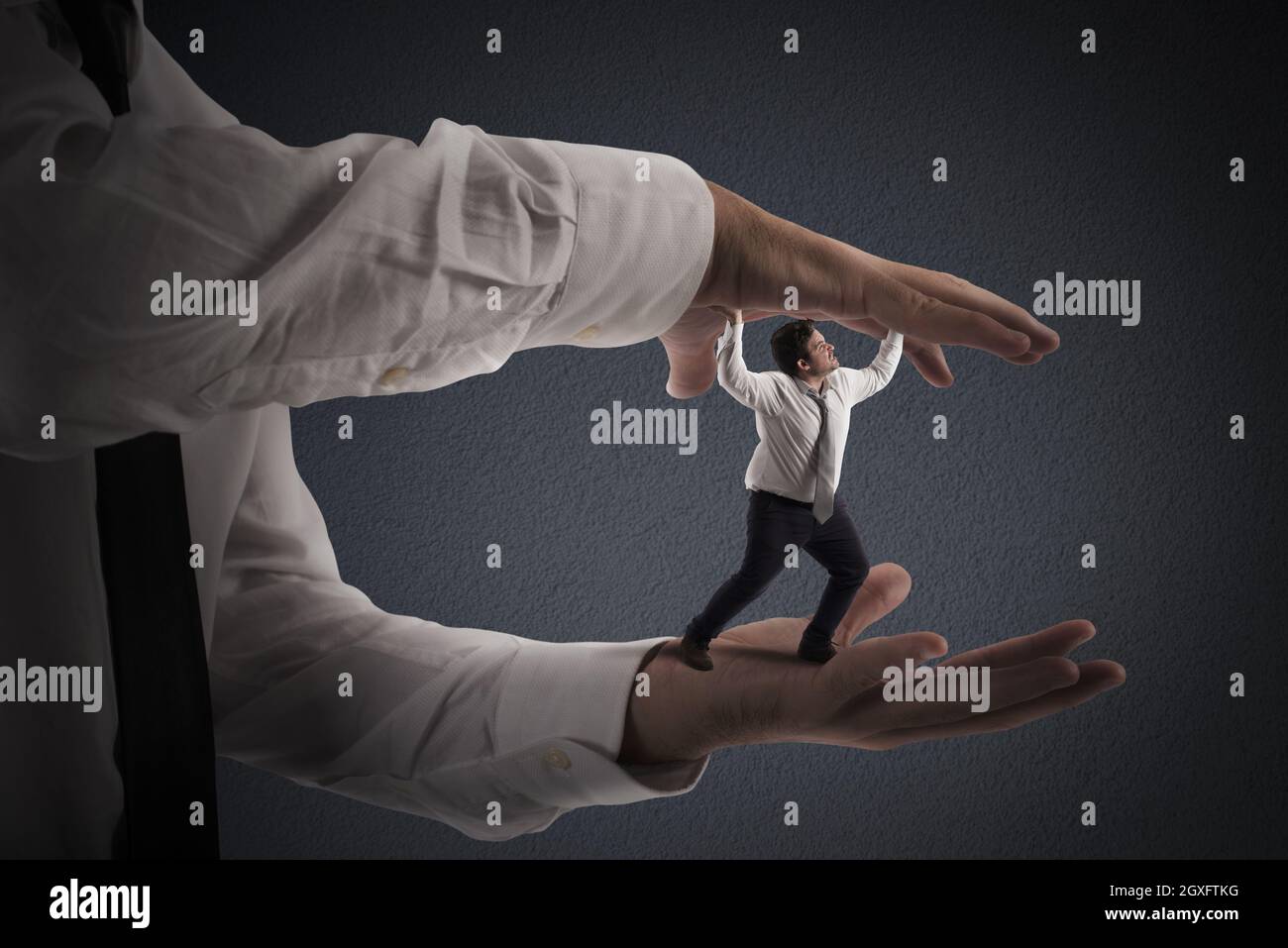 Big hands that crush a small man Stock Photo Alamy