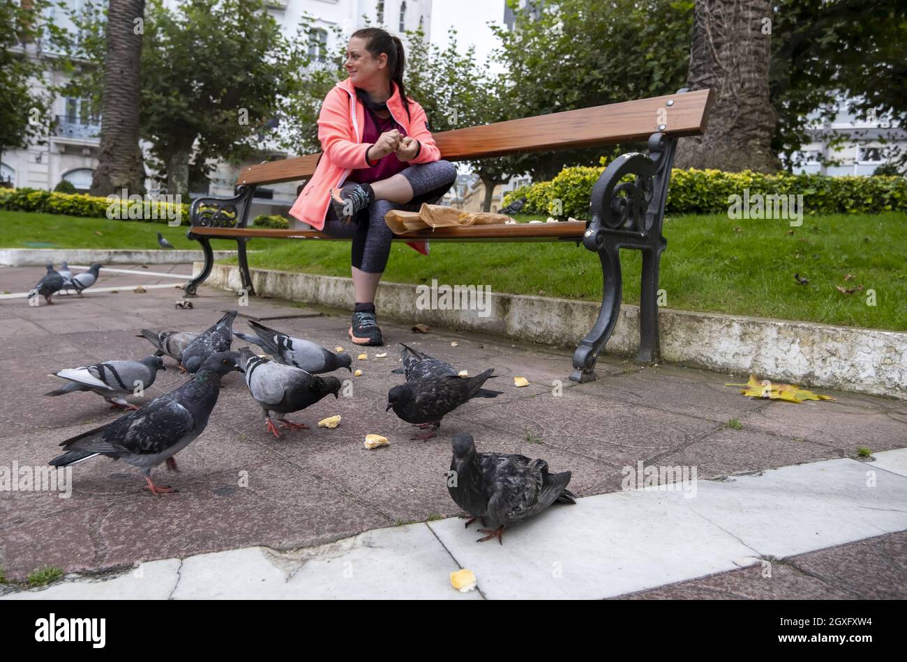 Detail of young woman feeding birds in the city Stock Photo Alamy