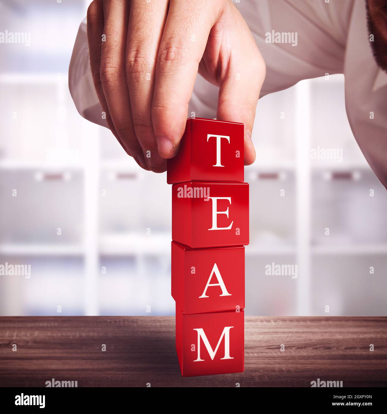 Man make a building with red cubes Stock Photo - Alamy