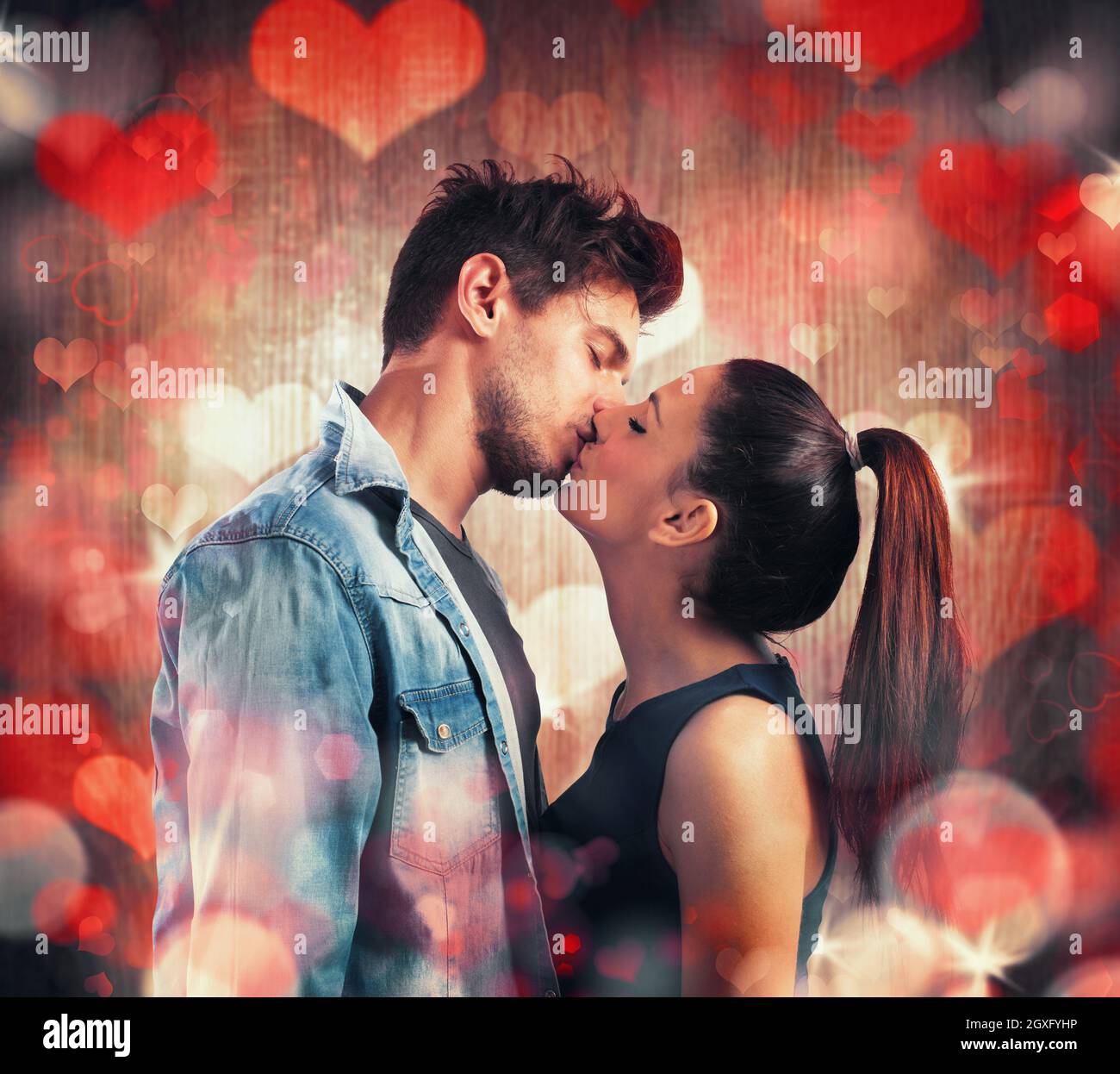 Girl and boy kissing with red hearts Stock Photo - Alamy
