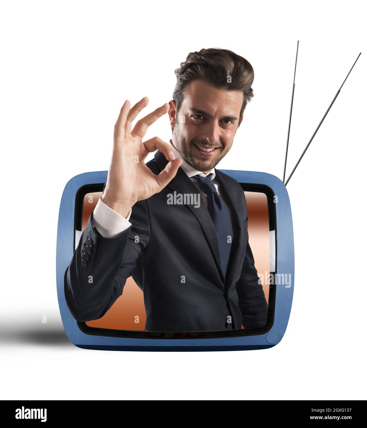 Smiling man comes out of vintage TV Stock Photo