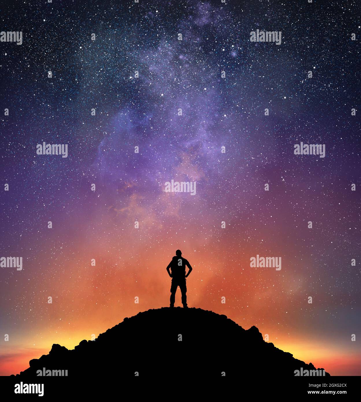 Excursionist on a mountain observe a bright sky full of stars Stock Photo