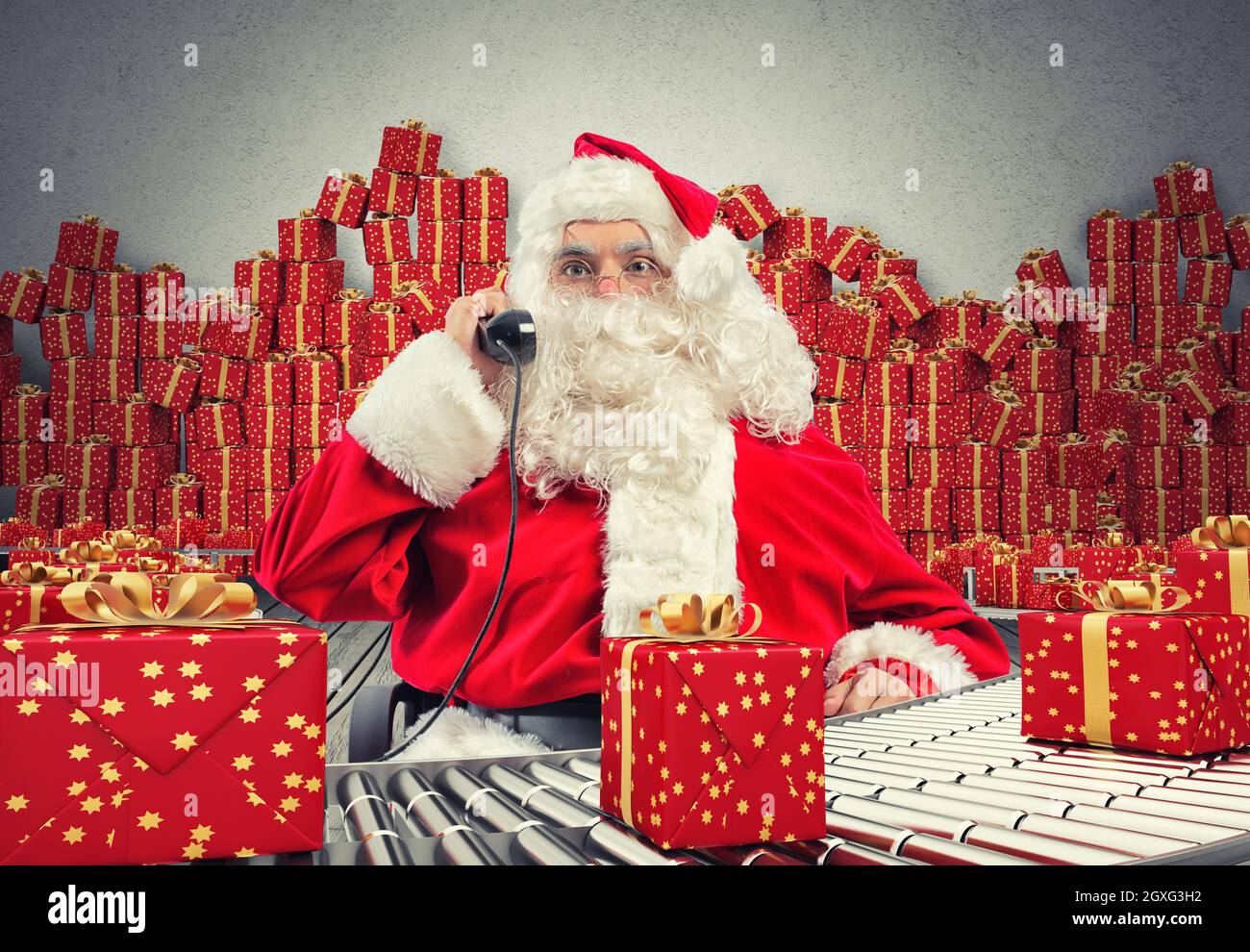 3D Rendering Santa Claus receives requests via telephone sitting in a chair and checking xmas gift boxes and wrapped on conveyor roller Stock Photo