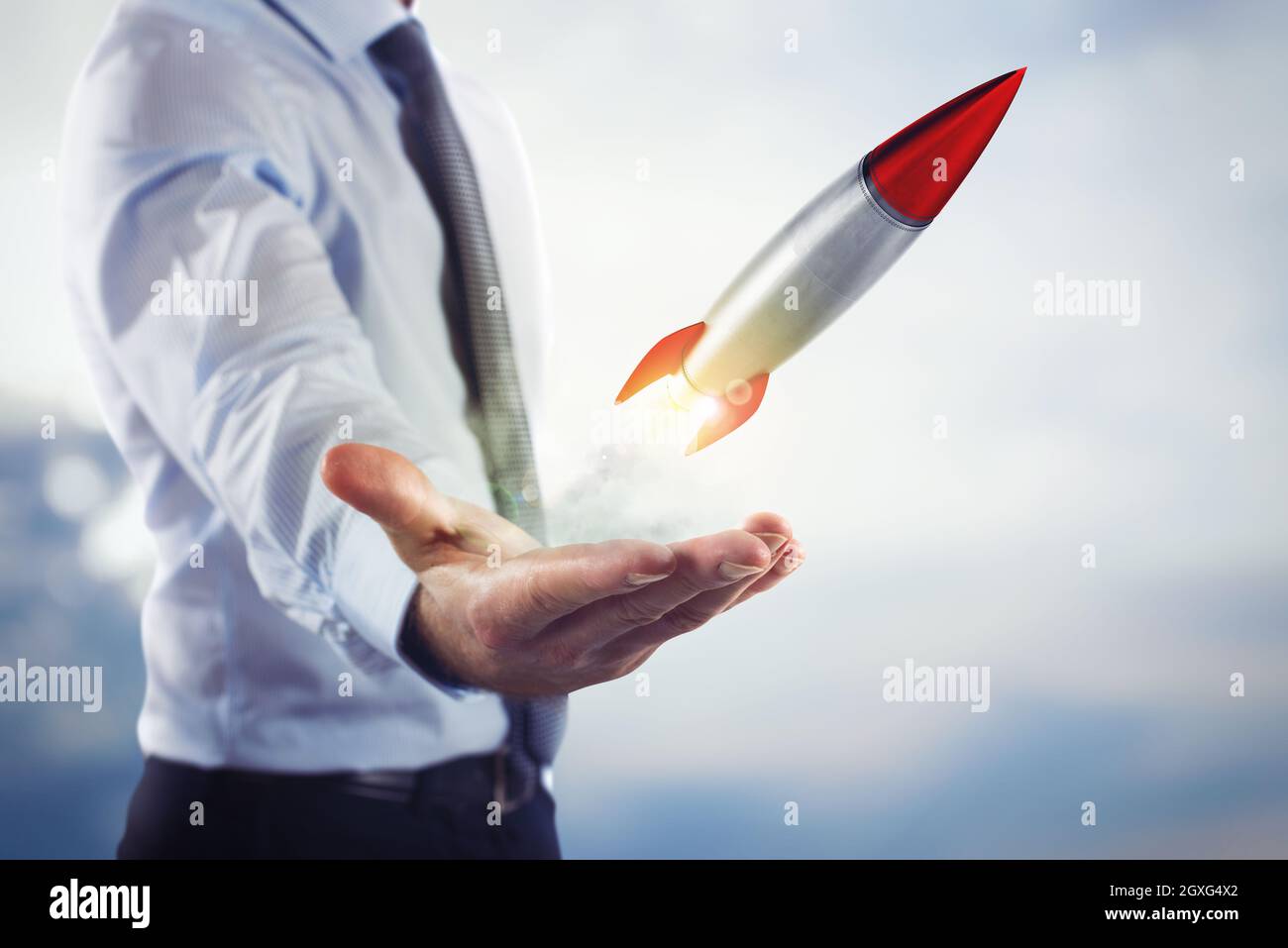 Businessman holding a small rocket. Startup working enterprise concept Stock Photo