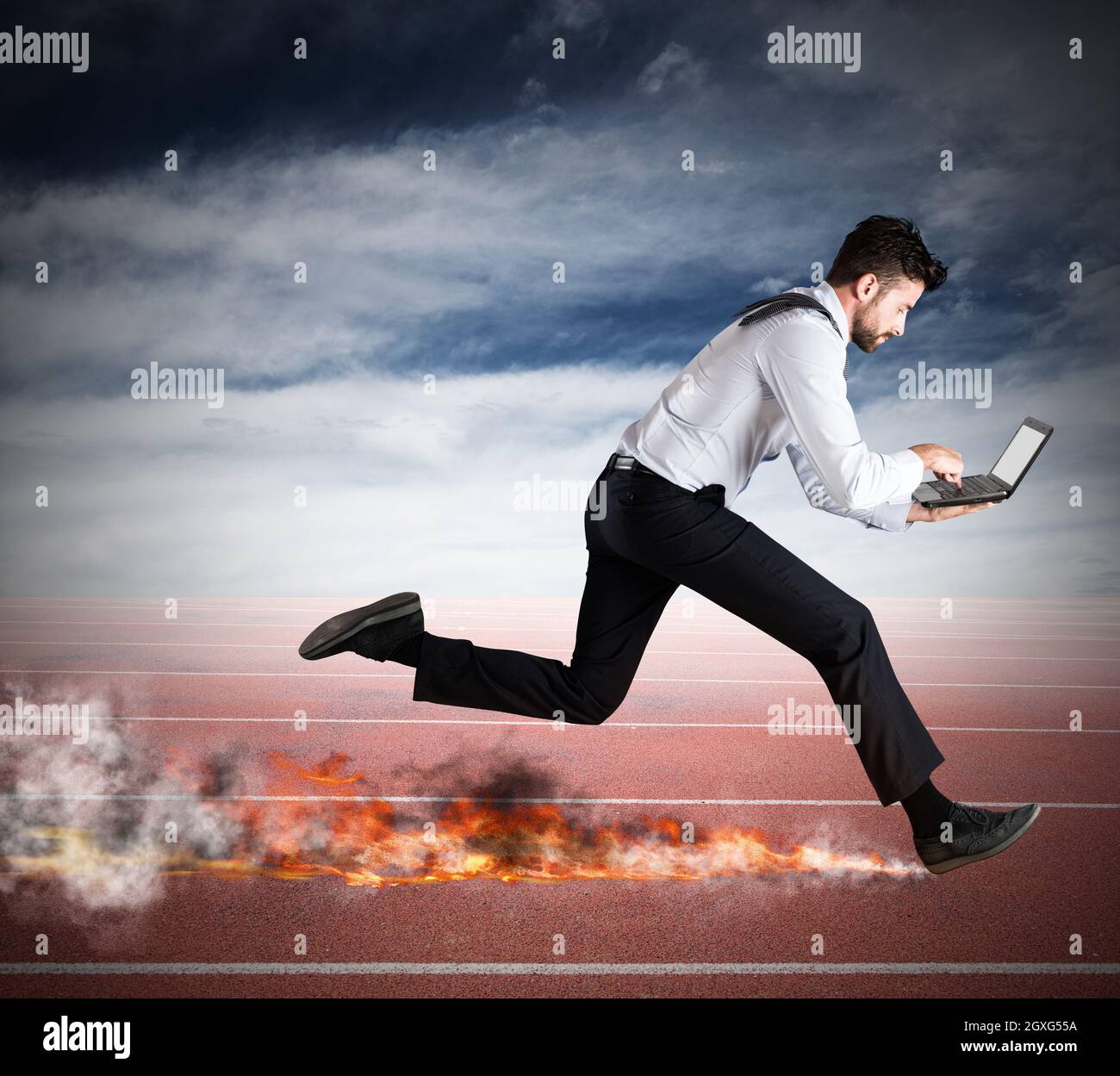 Businessman runs quickly with laptop leaving fire trails. Fast business ...